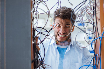 Computer repairman working on repairing network in IT workshop