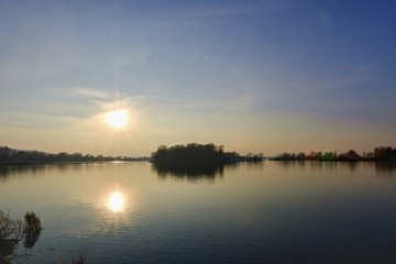 Sunset above the lake. Lake in winter.