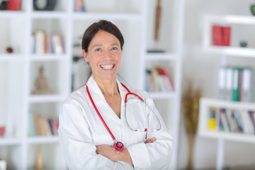 mid age female doctor smiling arms crossed