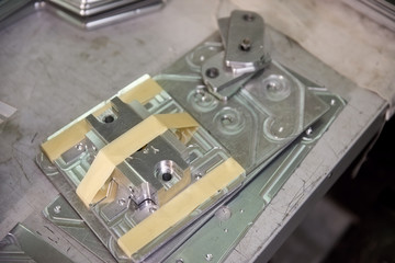 Steel parts, close up. Metal component on workshop desk.