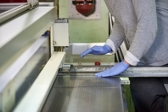 Guillotine shear machine in action. Guillotine shear machine is shearing a metal sheet.