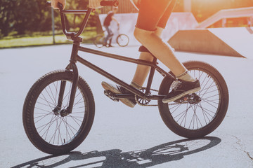 Bmx rider performing tricks at skatepark.