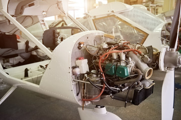 Airplane production, engine. Light aircraft in workshop.