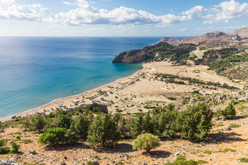 Stony landscape and a view of the Tsambika beach on the Rhodes Island, Greece