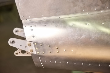 Airplane fuselage close up. Metal with rivets.