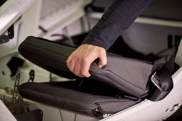 Folded seat unfolding. Airplane seat.