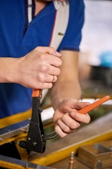 Man is working with a pop rivet gun. Laborer is working with a pop rivet gun, close-up.