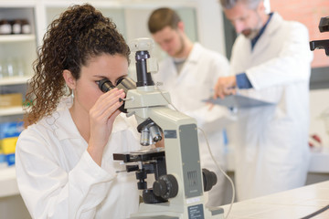 female researcher with a microscope