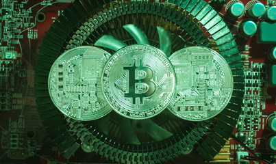 three silver coins bitcoin are on the heatsink of the video card
