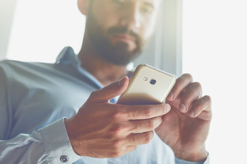 Handsome businessman using smart phone