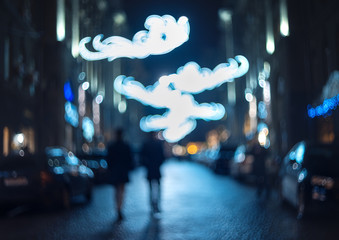 Blurred city at night. Bokeh. Beautiful abstract background with defocused buildings, cars, city...