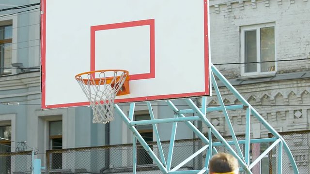 Player dribbling ball from center of field, putting it in basket and missing