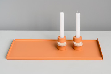 Metal orange support and candlesticks