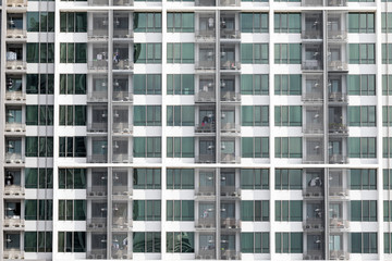 Fototapeta na wymiar Apartment windows showing a new high rise condo with good real estate rentals and spaces to buy