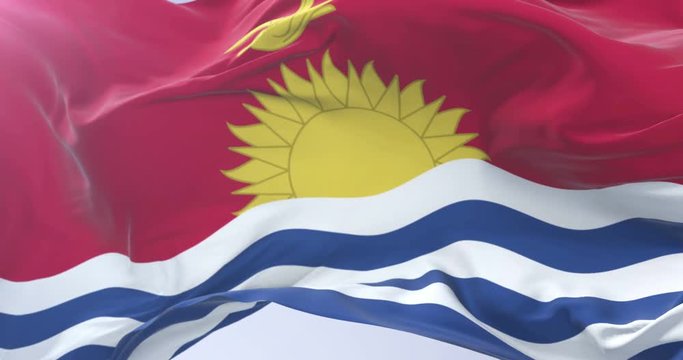 Kiribati flag waving at wind in slow in blue sky, loop
