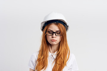 red-haired woman in helmet on light background