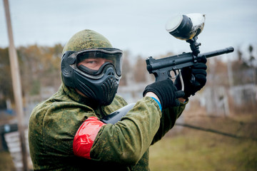Fototapeta premium Man with gun playing at paintball. Outdoors