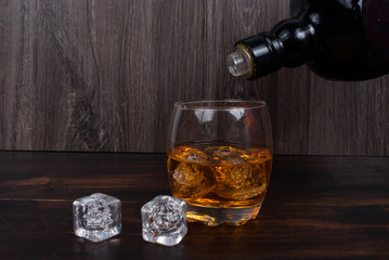 whisky on the rock on wood and wood background
