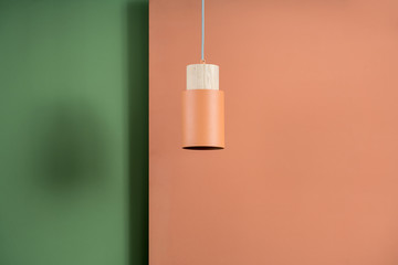Hanging metal orange lamp with wooden part
