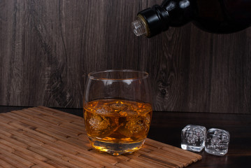 whisky on the rock on wood and wood background