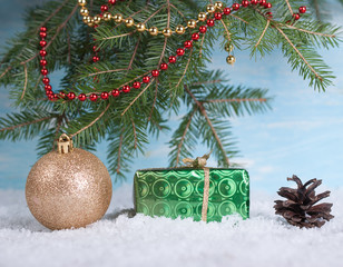 Christmas background with a ball of a tree with a green box and a cone