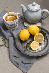 Cup of tea with lemon on table close-up. Healthcare traditional medicine and flu treatment concept.