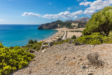 Fototapeta premium Stony landscape and a view of the Tsambika beach on the Rhodes Island, Greece