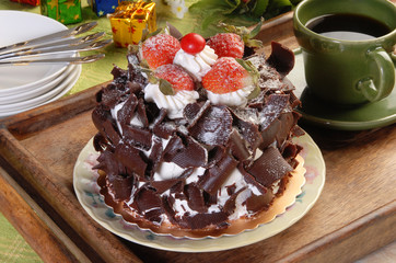 Chocolate cake with strawberries on  green tablecloth  