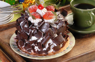 Chocolate cake with strawberries on  green tablecloth  