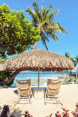 Two Sun-loungers and Tiki hut sun umbrella