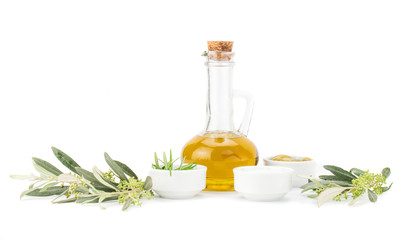 Glass bottle of premium virgin olive oil, lemon and some olives with olive branch isolated on a white background.