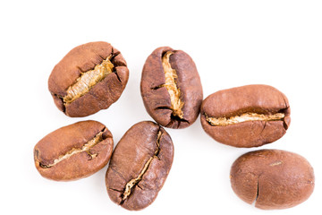 Roasted coffee beans on wood texture background.