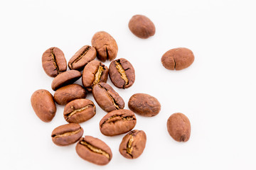 Roasted coffee beans on wood texture background.