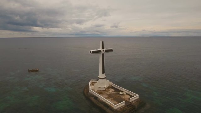 Aerial view Sunken Cemetery cross in Camiguin Island, Philippines. Large crucafix marking the underwater sunken cemetary of the coast of camiguin island near mindanao in the Philippines. Catholic