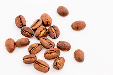 Roasted coffee beans on wood texture background.