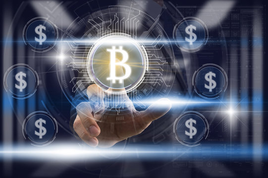 Businessman Finger touching the bitcoin icon over the currency dollar icon and light from blurred server room background, Fintech and AI concept