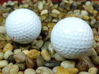 golf ball on river stone background close up
