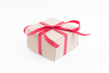 Brown gift box with red ribbon on white background