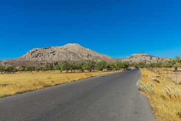 A road to Kolymbia, a sun-soaked resort in an idyllic place between mountains and the sea. Rhodes, Greece 