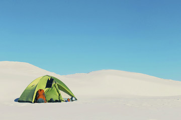 Winter trip. The tent is on top of a hill.