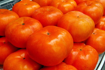 A cage of persimmon fruit for sale at marke