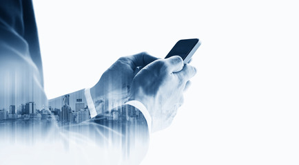 Double exposure businessman using mobile smart phone with modern buildings, on white background