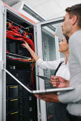 Team of technicians working together on servers at the data centre