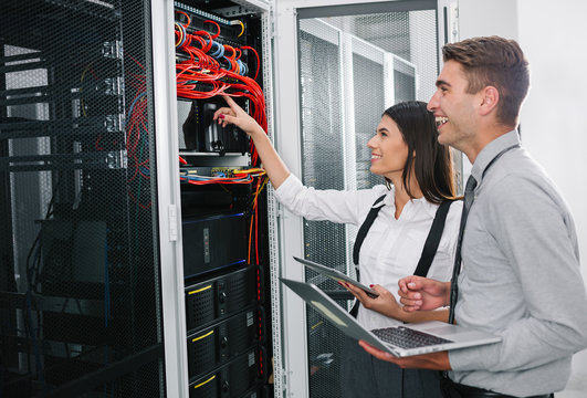 Team of technicians working together on servers at the data centre