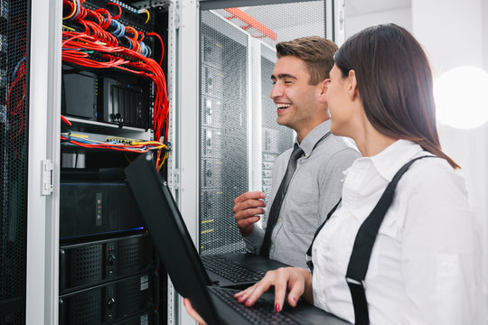 Team of technicians working together on servers at the data centre