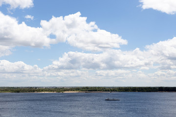 Blue sky, clouds, river and horizon