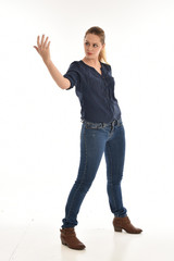 full length portrait of air wearing blue shirt and denim pants, standing pose on white background.