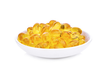 fish oil capsules with omega 3 and vitamin D in the white plate isolated on white background