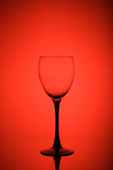 Wine glass on red background