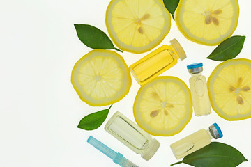 Vitamin C. Serum with Vitamin C, ampoule, syringe, lemon slices and lemon leaves. biorevitalization...
